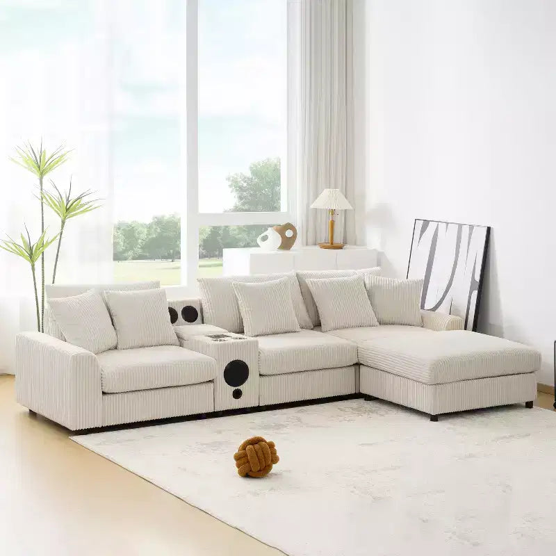 Divano componibile a L in velluto a coste da 114''W con altoparlanti Bluetooth, caricatore USB, portabicchieri e pouf - ModernLuxe