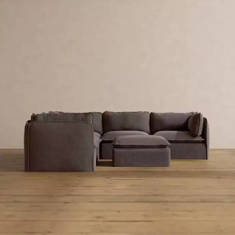 Divano componibile angolare Anabei lavabile a 5 posti + pouf | seduta Deluxe+ e cuscino cloud