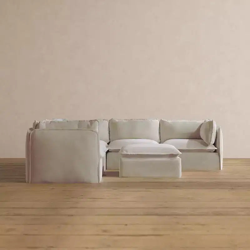 Divano componibile angolare Anabei lavabile a 5 posti + pouf | seduta Deluxe+ e cuscino cloud
