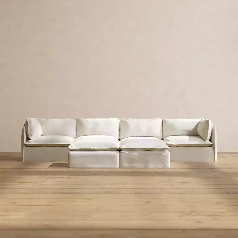 Divano componibile Anabei lavabile, 4 posti + pouf a panca | seduta Deluxe+ e cuscino cloud